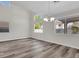 Dining room featuring neutral paint, gray-toned wood flooring and contemporary lighting at 6909 Fruit Flower Ave, Las Vegas, NV 89130