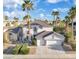 Charming two-story home featuring a two-car garage, desert landscaping, and mature palm trees at 6909 Fruit Flower Ave, Las Vegas, NV 89130