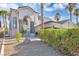 Charming two-story home featuring a desert landscaping and mature palm trees at 6909 Fruit Flower Ave, Las Vegas, NV 89130