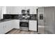 Kitchen featuring stainless steel appliances, modern white cabinets and granite counters at 6909 Fruit Flower Ave, Las Vegas, NV 89130