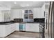 Well-lit kitchen with stainless steel appliances, modern white cabinets and granite countertops at 6909 Fruit Flower Ave, Las Vegas, NV 89130