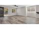Open living room featuring gray-toned wood flooring and sliding glass door at 6909 Fruit Flower Ave, Las Vegas, NV 89130