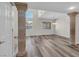 Bright living room featuring hardwood floors, decorative pillars, and large windows at 6909 Fruit Flower Ave, Las Vegas, NV 89130