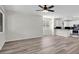 Open concept living room and kitchen featuring modern ceiling fan at 6909 Fruit Flower Ave, Las Vegas, NV 89130