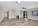 Spacious living room with fireplace, gray-toned floors, and sliding glass door at 6909 Fruit Flower Ave, Las Vegas, NV 89130