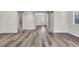 Bright living room featuring stone pillars and attractive gray-toned wood flooring at 6909 Fruit Flower Ave, Las Vegas, NV 89130