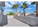 Wide patio area with palm trees visible above neighboring rooftops creating a private and tropical-feeling space at 6909 Fruit Flower Ave, Las Vegas, NV 89130