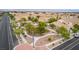 An aerial view of a community park surrounded by residences, streets, and sidewalks at 6916 Gothic Marigold St, Las Vegas, NV 89149