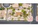 Aerial shot of a neighborhood park featuring curved walkways, scattered trees, and nearby residential houses at 6916 Gothic Marigold St, Las Vegas, NV 89149