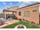 Backyard featuring patio, artificial grass, fire pit and desert landscaping at 6916 Gothic Marigold St, Las Vegas, NV 89149