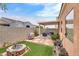 Spacious backyard featuring patio, artificial grass, block wall, and desert landscaping at 6916 Gothic Marigold St, Las Vegas, NV 89149