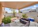Backyard featuring patio with comfortable seating, artificial grass, and desert landscaping at 6916 Gothic Marigold St, Las Vegas, NV 89149