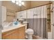 Well-lit bathroom featuring a vanity with sink and a shower/tub combo with a 'love' shower curtain at 6916 Gothic Marigold St, Las Vegas, NV 89149