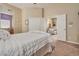 Comfortable bedroom with neutral walls, carpet flooring, white bed, and a view into the adjacent sitting room at 6916 Gothic Marigold St, Las Vegas, NV 89149