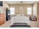 Bright bedroom showcasing neutral walls, a white bed frame, and carpet flooring at 6916 Gothic Marigold St, Las Vegas, NV 89149