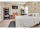 Cozy bedroom with a plush bed, adjacent shelves, television, and plenty of natural light at 6916 Gothic Marigold St, Las Vegas, NV 89149
