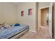 Bedroom showcasing neutral colors, carpet, and open doorway to the hallway at 6916 Gothic Marigold St, Las Vegas, NV 89149