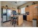 Well-equipped kitchen with stainless steel refrigerator and a central island with seating at 6916 Gothic Marigold St, Las Vegas, NV 89149