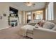Comfortable living area showcasing a fireplace and an open layout into the dining area at 6916 Gothic Marigold St, Las Vegas, NV 89149