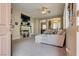Cozy living room featuring a fireplace, ceiling fan, and neutral color palette at 6916 Gothic Marigold St, Las Vegas, NV 89149