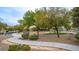Serene community park featuring green grass, mature shade trees, meandering sidewalks and a picnic area at 6916 Gothic Marigold St, Las Vegas, NV 89149