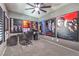 Spacious bedroom with movie themed posters on the wall and comfortable seating at 7472 Garnet Moon St, North Las Vegas, NV 89084