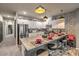 Contemporary kitchen with granite countertops, white cabinets, stainless steel appliances, and stylish pendant lighting at 7472 Garnet Moon St, North Las Vegas, NV 89084