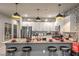 Modern kitchen featuring an island with seating, granite countertops, stainless steel appliances, and decorative backsplash at 7472 Garnet Moon St, North Las Vegas, NV 89084