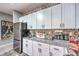 Well-lit kitchen featuring white cabinets, granite countertops, stainless steel appliances, and decorative tile backsplash at 7472 Garnet Moon St, North Las Vegas, NV 89084