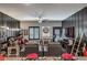 Inviting living area with hardwood flooring, a cozy seating arrangement, and a large ceiling fan at 7472 Garnet Moon St, North Las Vegas, NV 89084