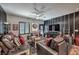 Cozy living room with hardwood floors, stylish furniture, modern ceiling fan, and a media center at 7472 Garnet Moon St, North Las Vegas, NV 89084