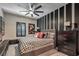 Comfortable bedroom featuring a ceiling fan, accent wall, and contemporary decor for a relaxing atmosphere at 7472 Garnet Moon St, North Las Vegas, NV 89084