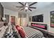 Well-appointed bedroom with an accent wall, modern entertainment unit, and organized closet space for comfort at 7472 Garnet Moon St, North Las Vegas, NV 89084