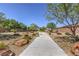 Scenic walking path lined with lush landscaping and mature trees, providing a tranquil outdoor space for residents at 7472 Garnet Moon St, North Las Vegas, NV 89084