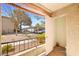 A cozy balcony with an open door and a view of the building's exterior and a parking space at 7885 W Flamingo Rd # 1131, Las Vegas, NV 89147