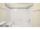 A well-lit tub and shower combo features white tile and a grey stripe accent at 7885 W Flamingo Rd # 1131, Las Vegas, NV 89147
