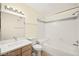 Clean bathroom featuring white tile and a shower-tub combination at 7885 W Flamingo Rd # 1131, Las Vegas, NV 89147