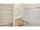A full bathroom features tile floors, open shelves, a large mirror, and a shower/tub combo at 7885 W Flamingo Rd # 1131, Las Vegas, NV 89147