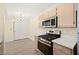 Modern kitchen with stainless steel appliances and sliding closet doors adjacent to dining area at 7885 W Flamingo Rd # 1131, Las Vegas, NV 89147