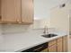 Contemporary kitchen featuring stainless steel sink, white countertops and light wood cabinetry at 7885 W Flamingo Rd # 1131, Las Vegas, NV 89147