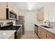 Well-lit kitchen with stainless steel appliances and light wood cabinets and white countertop at 7885 W Flamingo Rd # 1131, Las Vegas, NV 89147