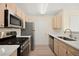 A well-lit kitchen features modern stainless steel appliances and light-colored wood cabinetry at 7885 W Flamingo Rd # 1131, Las Vegas, NV 89147