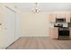 Living space with chandelier and kitchen view featuring modern appliances and finishes at 7885 W Flamingo Rd # 1131, Las Vegas, NV 89147