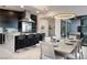 Elegant dining area with modern table and chairs, adjacent to a kitchen with granite island at 794 Willits St, Las Vegas, NV 89138
