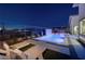 Backyard pool with water feature, surrounded by lounge chairs and landscaped area at nighttime at 794 Willits St, Las Vegas, NV 89138