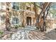 Inviting condo exterior featuring a walkway, mature trees and manicured landscape at 8070 W Russell Rd # 1023, Las Vegas, NV 89113