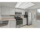 Modern kitchen features a window, stainless steel appliances, and white cabinets at 8070 W Russell Rd # 1023, Las Vegas, NV 89113