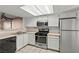 Bright kitchen features white cabinets, a black dishwasher, and stainless steel appliances at 8070 W Russell Rd # 1023, Las Vegas, NV 89113