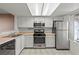 Well-lit kitchen with stainless steel appliances, white cabinets, and ample countertop space at 8070 W Russell Rd # 1023, Las Vegas, NV 89113