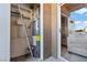 Enclosed condo patio featuring a water heater and sliding glass door at 8070 W Russell Rd # 1023, Las Vegas, NV 89113